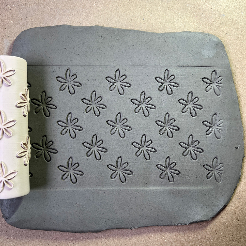 90mm flower line repeat roller with a carved floral pattern for creating detailed pottery textures.