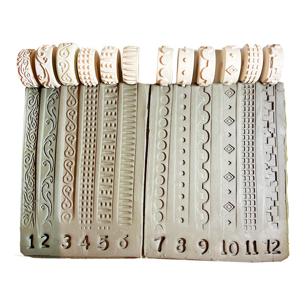 Complete set of 12 potter's stamps, each with unique patterns for adding texture to pottery.