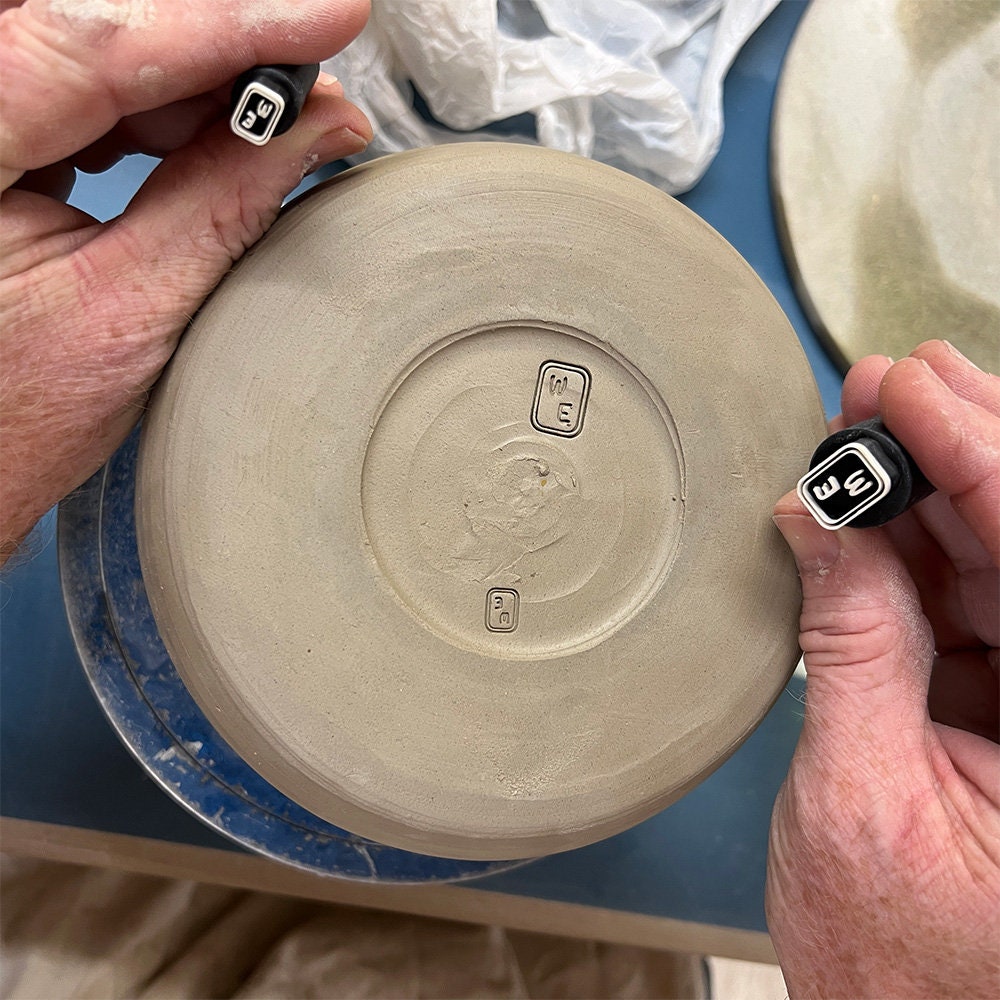 Ceramic stamp featuring a hand-held post for easy and accurate application.
