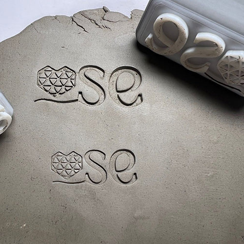 SE-themed custom potter’s mark stamp, ideal for personalized clay branding.