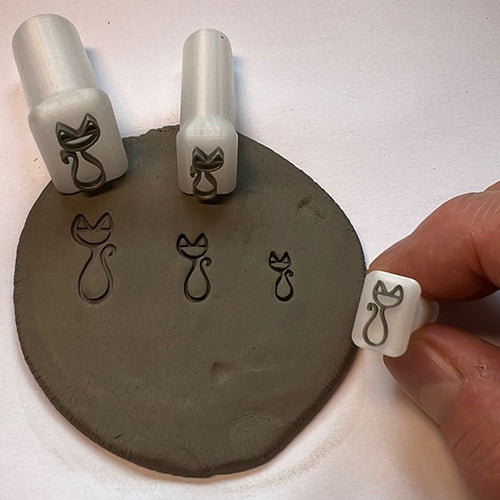 Cat-themed custom potter’s mark stamp for adding a whimsical touch to ceramics.