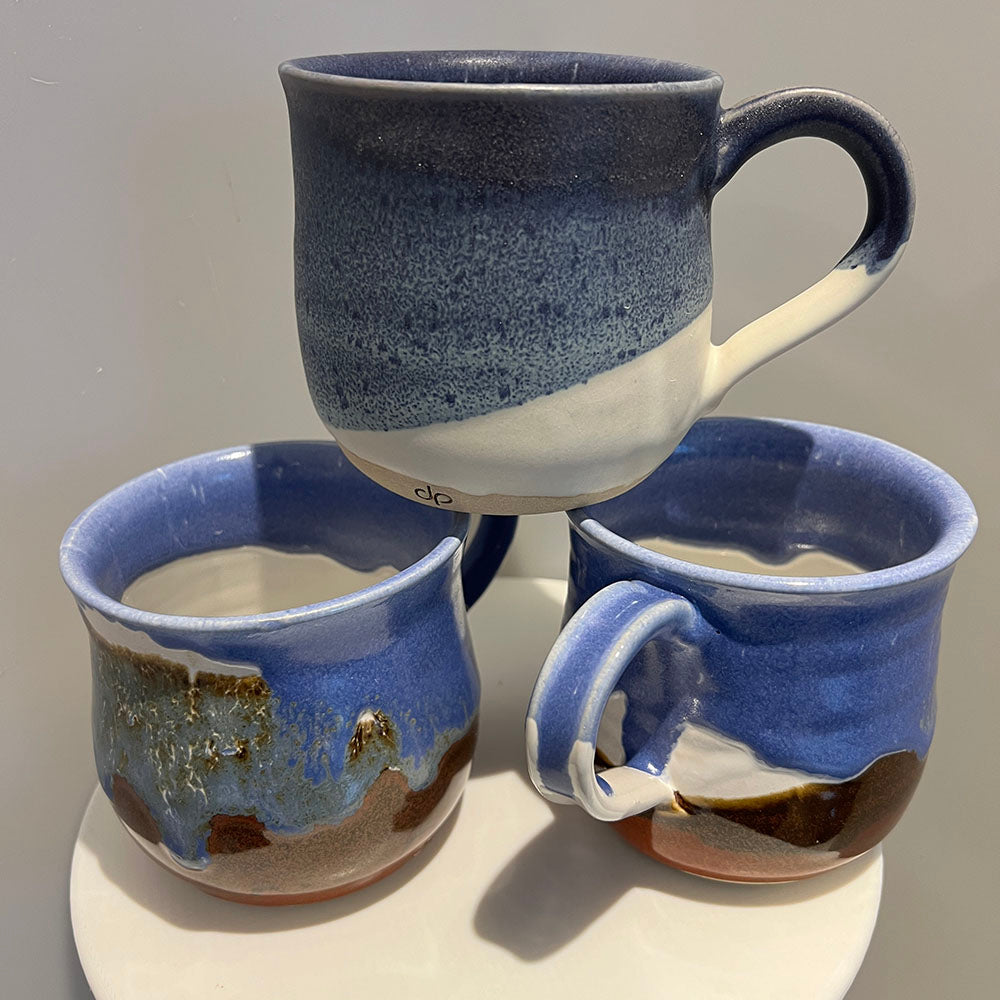 Mugs shaped using the Pottr mug rib tool, showcasing smooth, refined edges and detailed pottery craftsmanship.